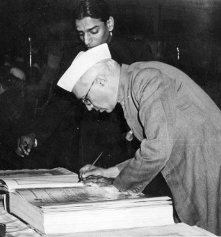 Nehru signing Indian Constitution